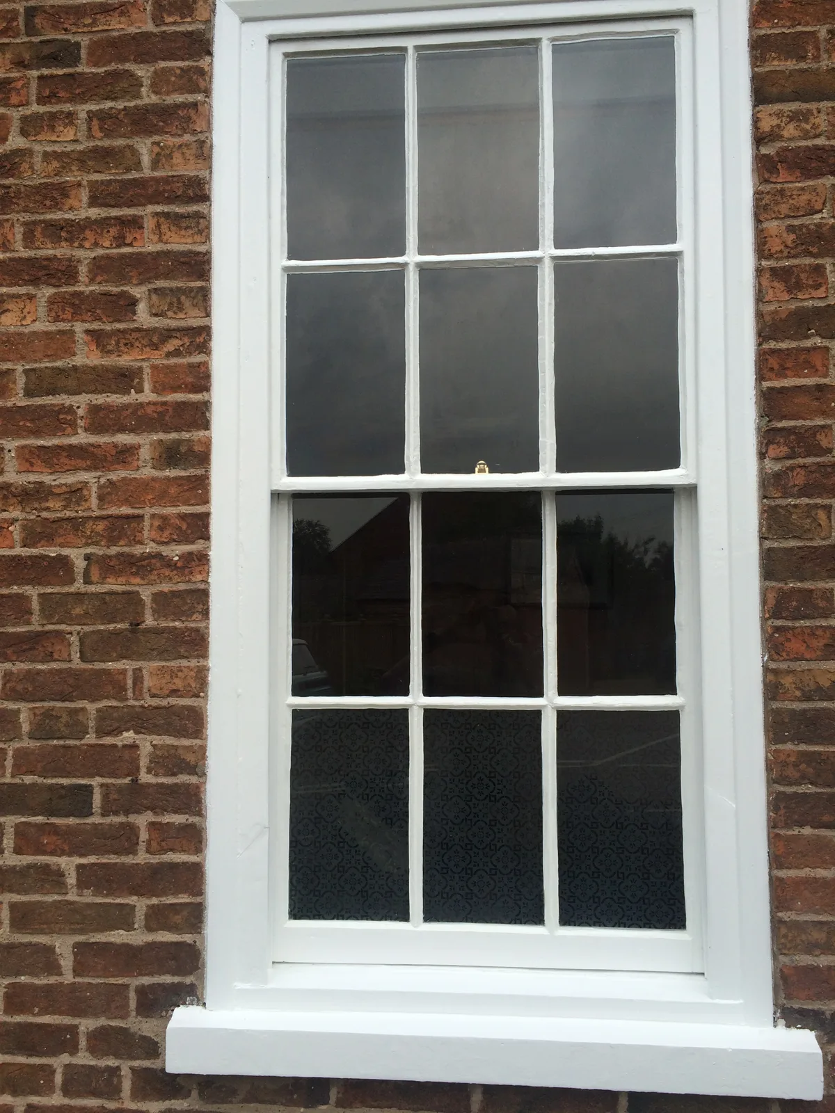 Finished Georgian sash window in brick exterior